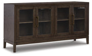 Ashley Furniture Burkhaus dining room set with oval table and six upholstered chairs, shown from an angled close-up view.