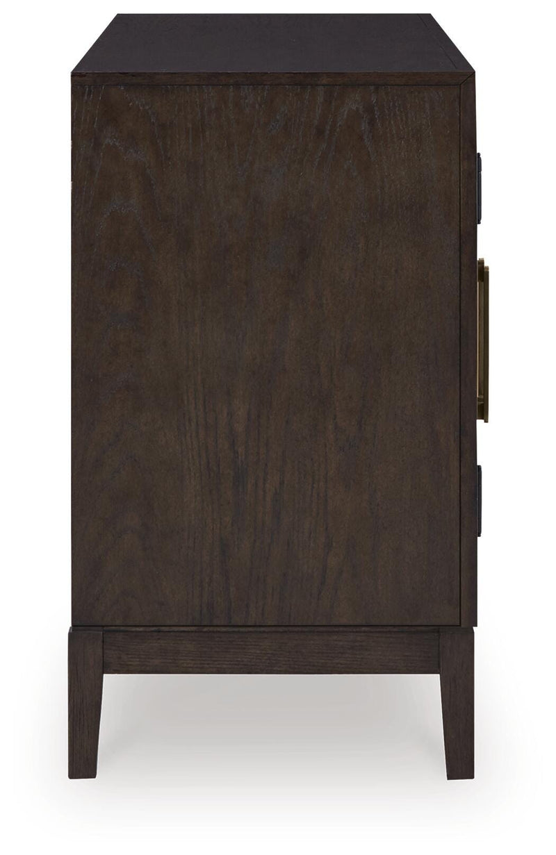 Ashley Furniture Burkhaus dining room set with a wooden table and matching chairs, shown from a side view.