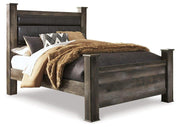 Ashley Furniture Wynnlow Bed with upholstered headboard and wooden frame, shown in a cozy bedroom setting.