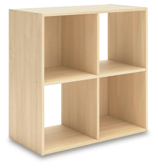 Ashley Furniture Piperton Cube Organizer with a 2x2 design, shown from an angled side view in a modern interior setting.