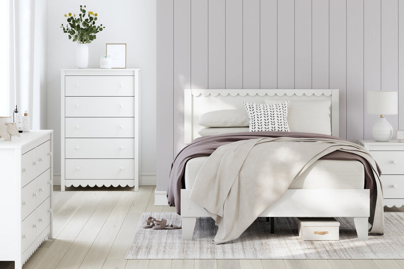 Ashley Furniture Hallityn chest of drawers with a modern wood finish and multiple storage drawers.