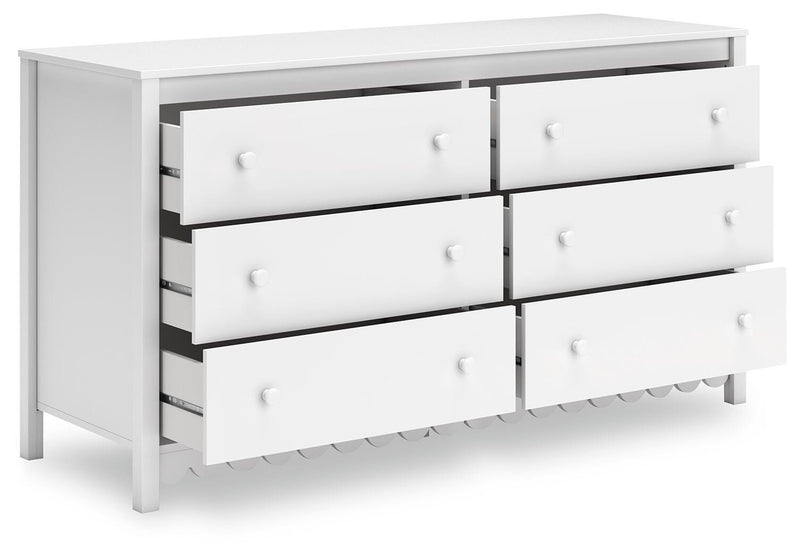 Ashley Furniture Hallityn dresser shown from an angle with open top drawers, showcasing its spacious storage and modern design.
