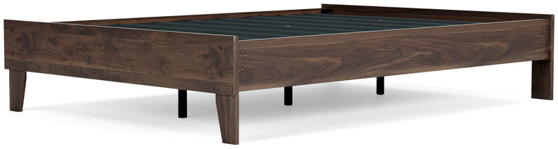 Ashley Furniture Calverson Bed with a dark wood finish and elegant headboard, shown from an angled view.
