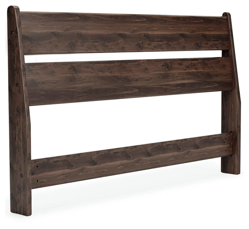Ashley Furniture Calverson Bed with a modern design, shown from an angle highlighting the headboard and sleek frame.