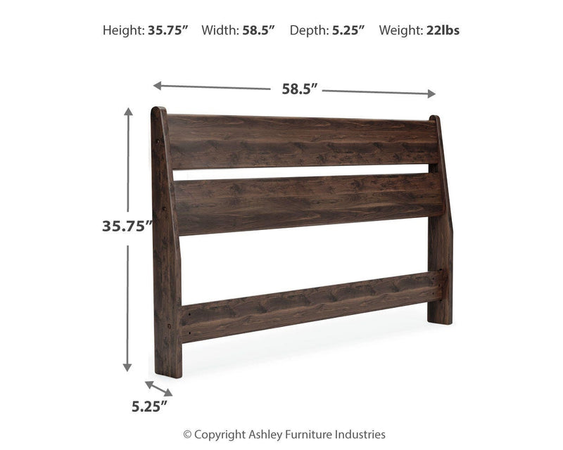 Ashley Furniture Calverson Bed with a wooden frame and upholstered headboard, shown in a modern bedroom setting.