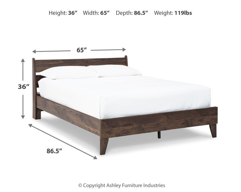 Ashley Furniture Calverson Bed with a classic wooden frame and upholstered headboard, shown in a modern bedroom setting.