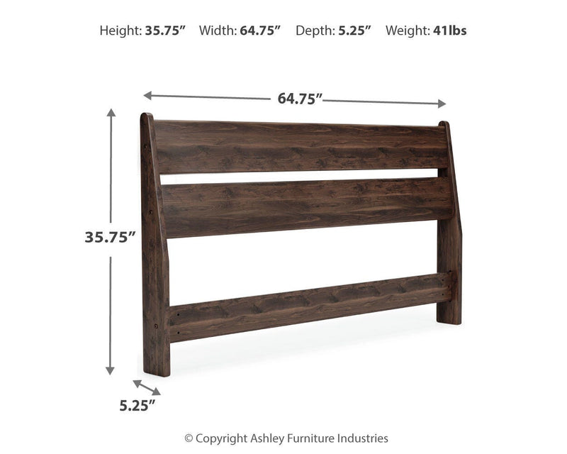 Ashley Furniture Calverson bed with a wooden frame and upholstered headboard, shown in a stylish bedroom setting.