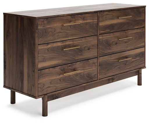 Angle view of Ashley Furniture Calverson Dresser showing its wooden finish and multiple spacious drawers.
