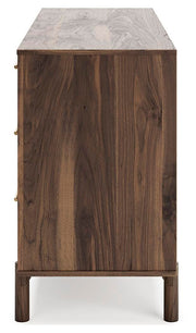 Ashley Furniture Calverson Dresser with four spacious drawers and modern wood finish, shown from a side angle.