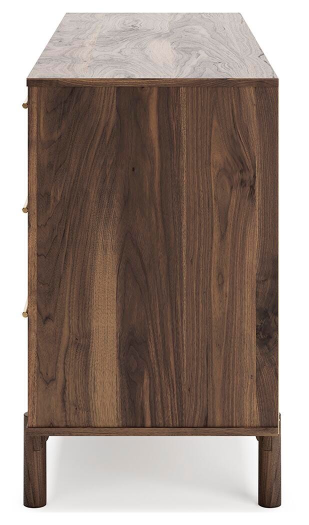 Ashley Furniture Calverson Dresser with four spacious drawers and modern wood finish, shown from a side angle.