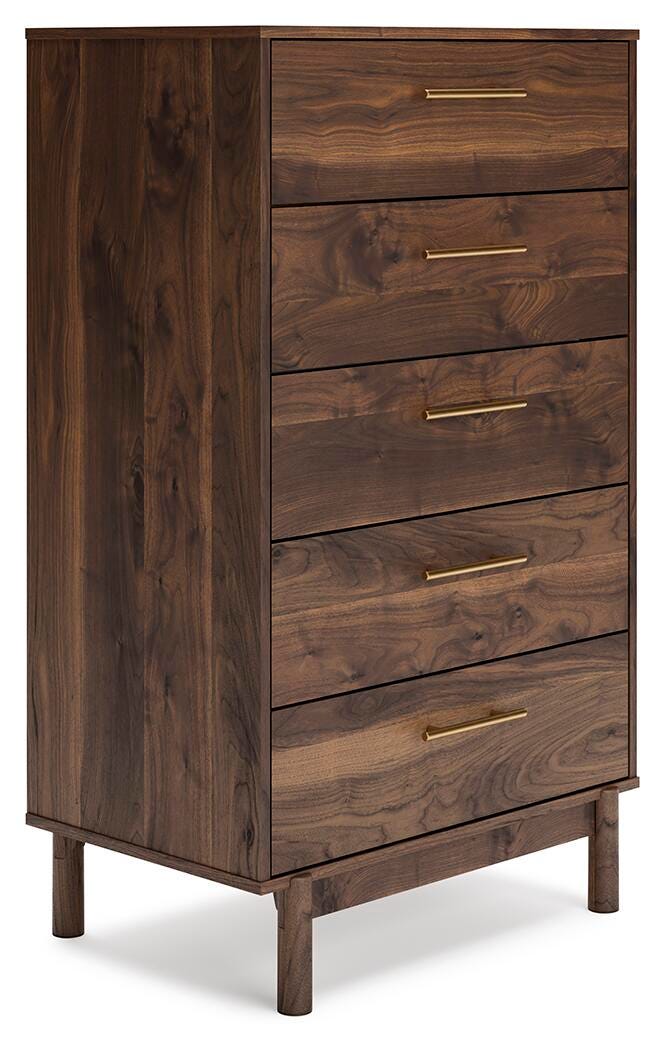 Ashley Furniture Calverson chest of drawers with a sleek modern design, shown from an angled view highlighting its wood finish.