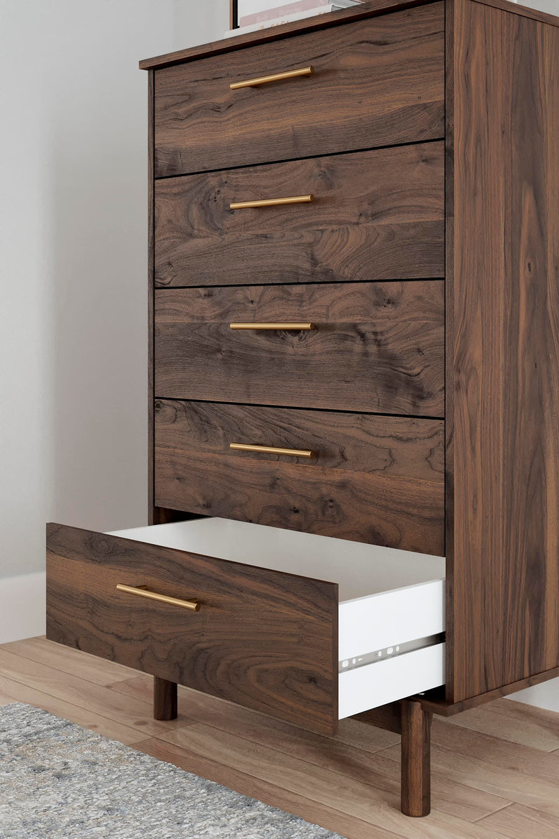 Close-up of the Ashley Furniture Calverson Chest of Drawers showing its detailed wood finish and sleek drawer handles.