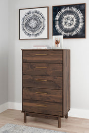 Ashley Furniture Calverson chest of drawers with dark wood finish and silver hardware, featuring multiple drawers for storage.