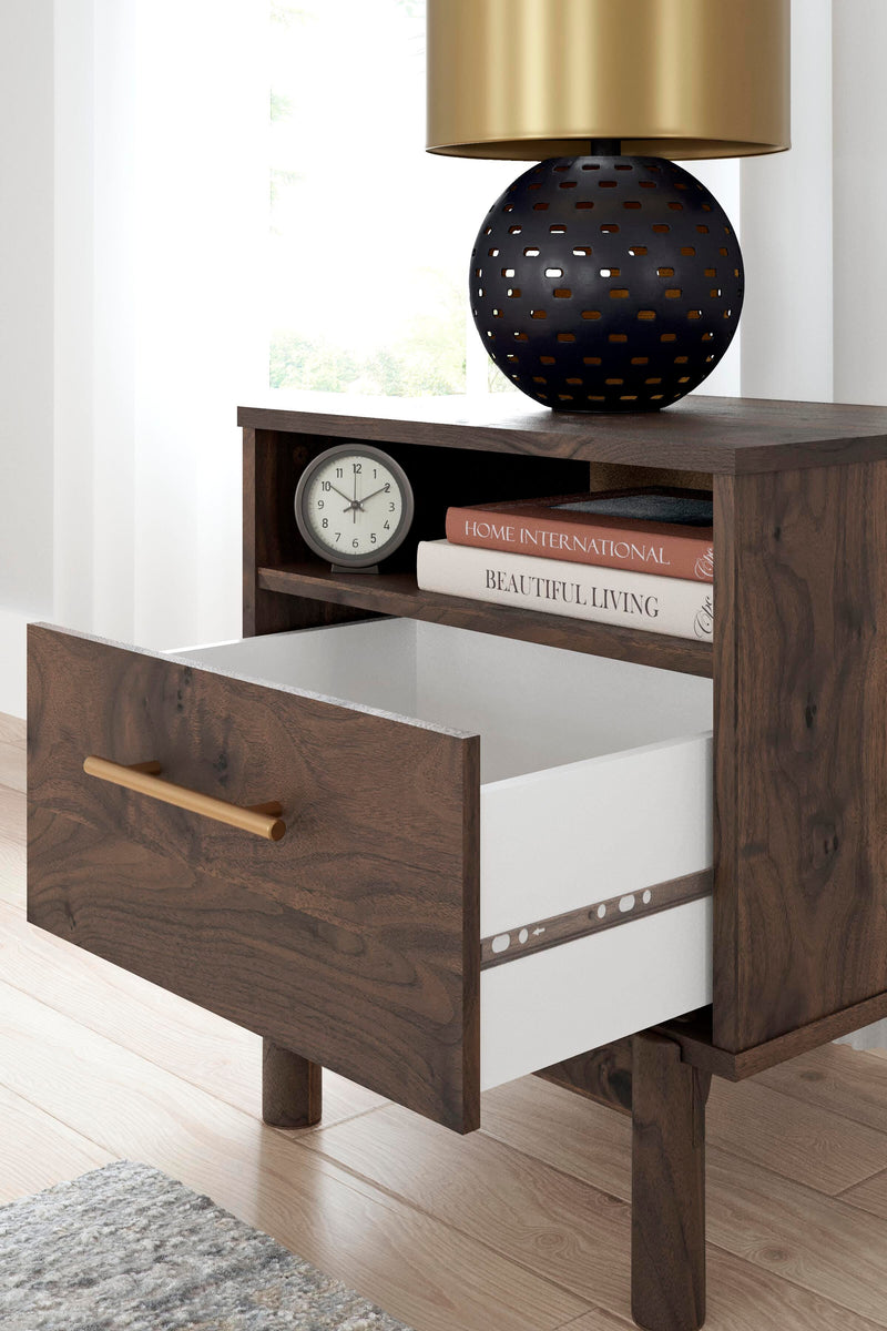 Ashley Furniture Calverson nightstand with a dark wood finish and modern design, featuring a single drawer and open shelf.