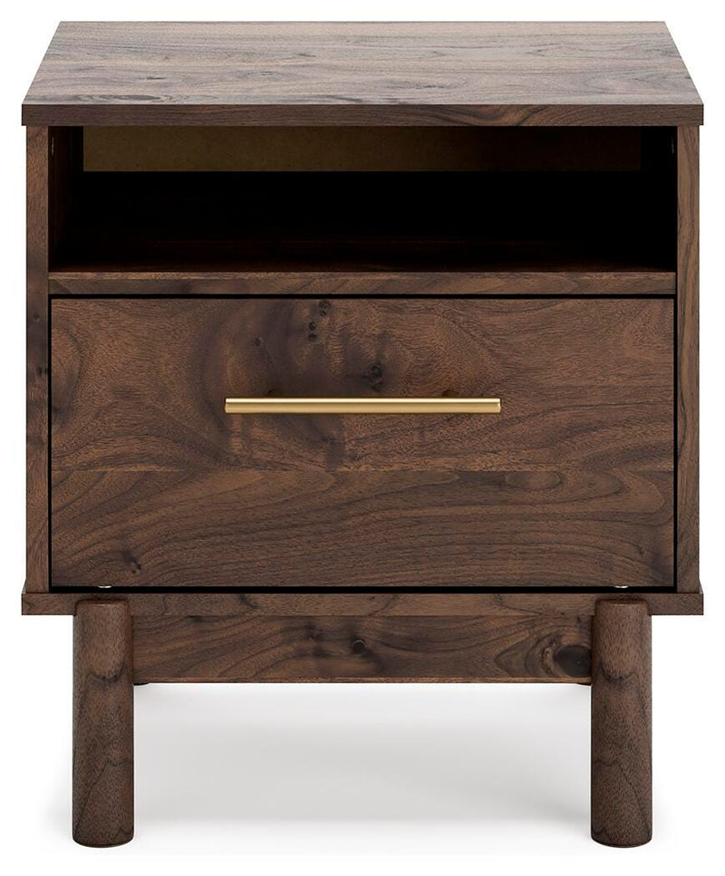Ashley Furniture Calverson Nightstand with a sleek wood finish and modern design, featuring a single drawer and open shelf.