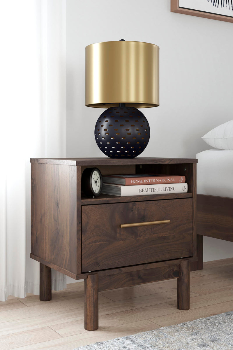 Ashley Furniture Calverson nightstand with two drawers and a dark wood finish, displaying a modern bedroom decor.