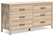 Ashley Furniture Battelle Dresser with six drawers and modern wood finish, shown from an angled side view.