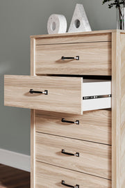 Detail of Ashley Furniture Battelle Chest of Drawers showing wood finish and elegant drawer handles.