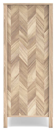 Ashley Furniture Battelle chest of drawers with a sleek wood finish and multiple storage drawers, shown from a side angle.