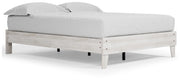 Ashley Furniture Shawburn Queen platform bed with a sleek wooden frame and neutral finish, shown from an angled side view.