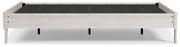Ashley Furniture Shawburn Queen platform bed with a sleek frame and neutral fabric upholstery, shown from a side view.