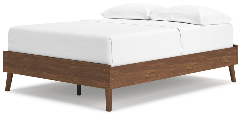 Ashley Furniture Fordmont Bed with upholstered headboard and wooden frame, shown from an angled perspective.