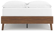 Ashley Furniture Fordmont bed with a dark wood finish and classic headboard design, shown in a cozy bedroom setting.