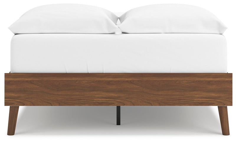 Ashley Furniture Fordmont bed with a dark wood finish and classic headboard design, shown in a cozy bedroom setting.