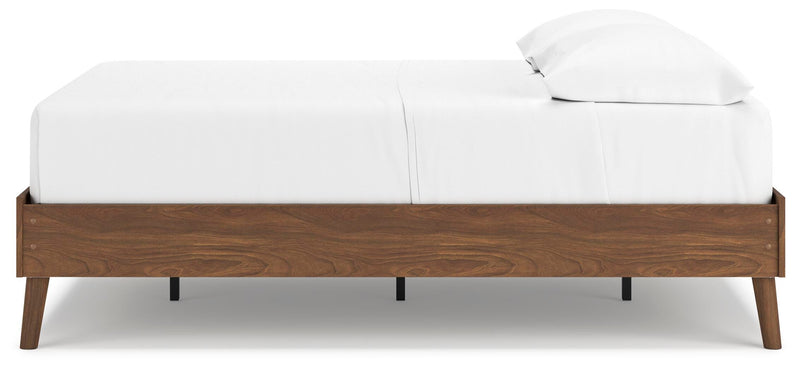 Ashley Furniture Fordmont Bed with a dark wood finish and elegant panel design, shown from a side angle.