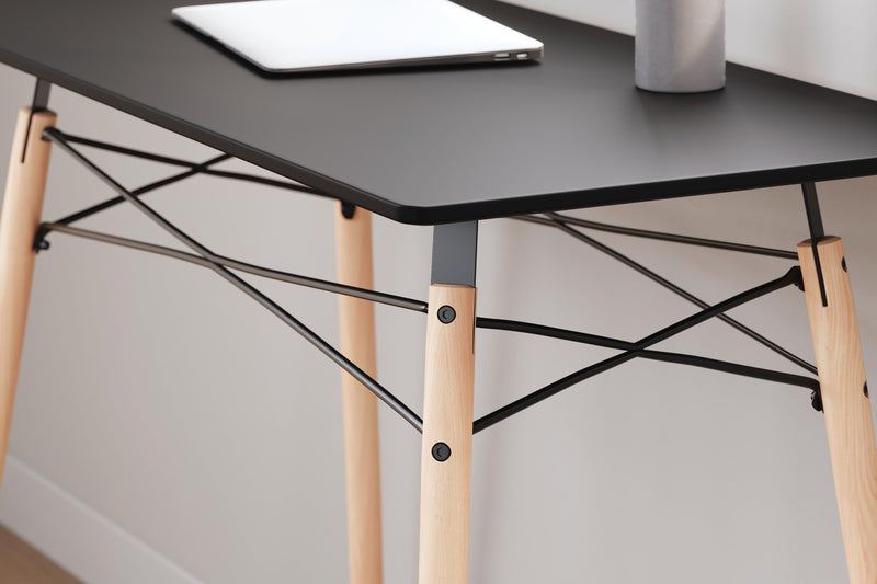 Ashley Furniture Jaspeni home office desk with a sleek wooden surface and modern design, ideal for workspace organization.