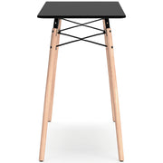 Ashley Furniture Jaspeni home office desk with a sleek wooden surface and modern design, shown from a side angle.
