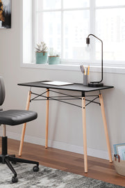 Ashley Furniture Jaspeni home office desk with a sleek wooden surface and modern design, ideal for workspace organization.