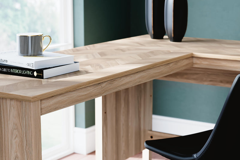 Ashley Furniture Battelle 60-inch home office desk with return, featuring a modern design and spacious work surface.