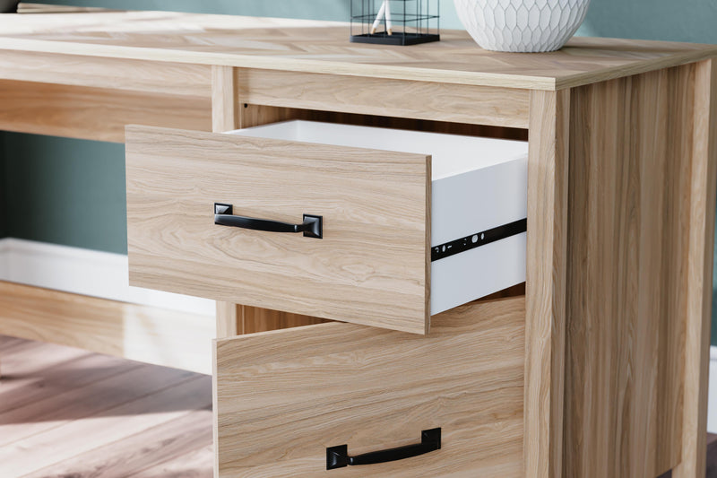 Ashley Furniture Battelle 60-inch home office desk with a sleek wood finish and spacious work surface.