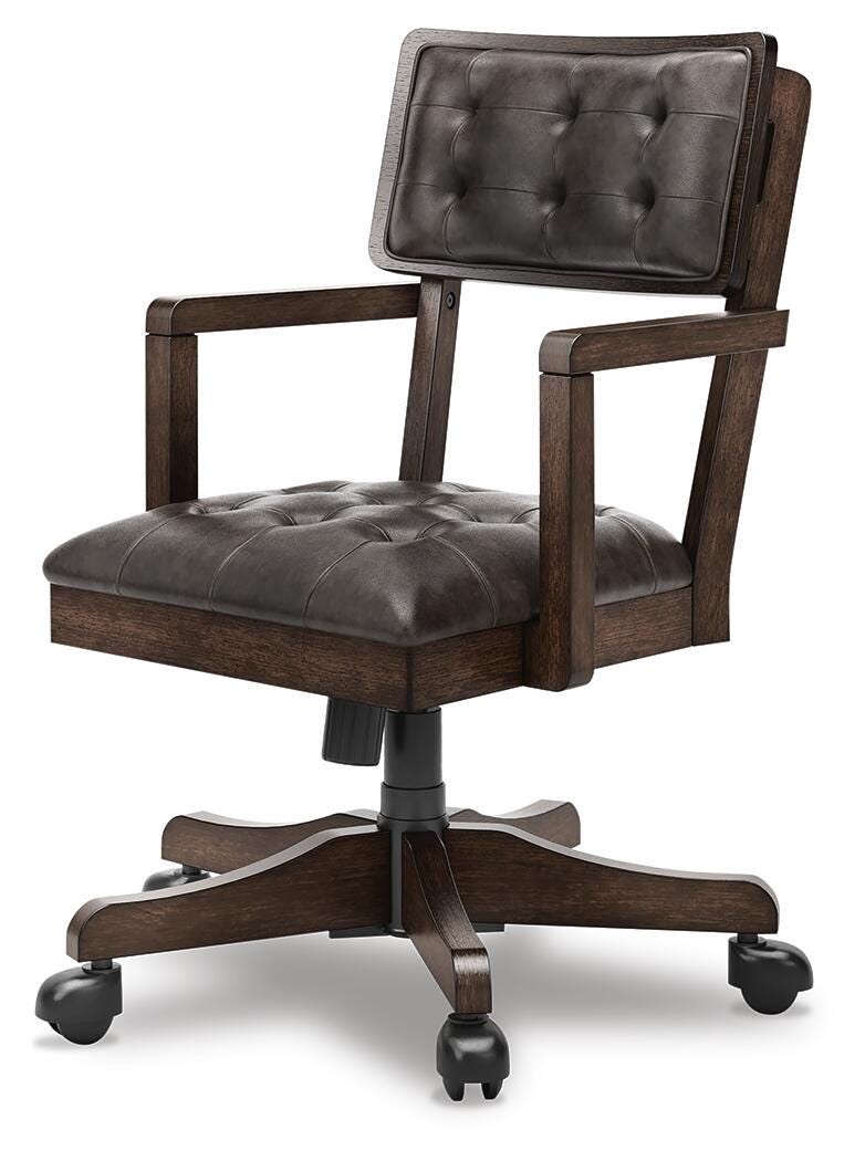 Ashley Furniture Breckington home office set with wooden desk, matching bookshelf, and comfortable office chair in a modern workspace setting.