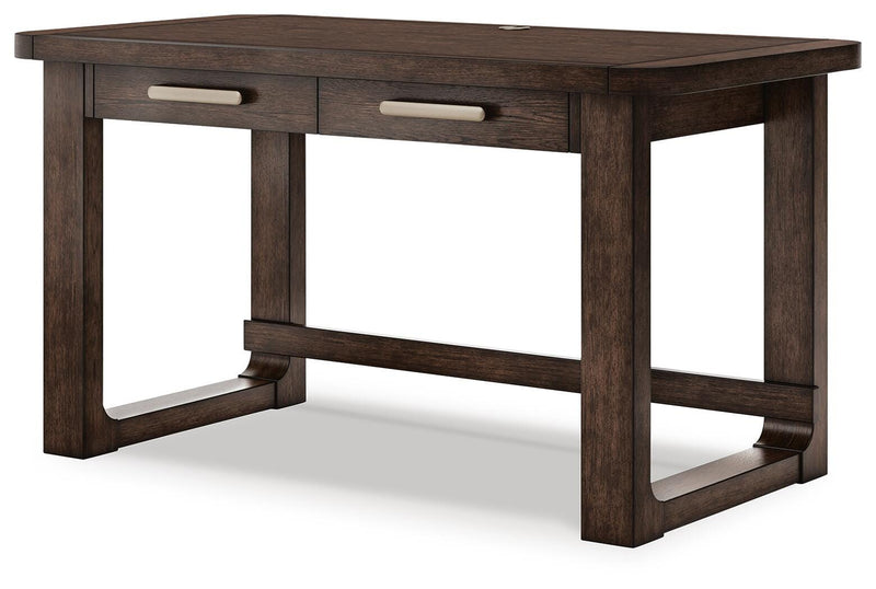 Ashley Furniture Breckington home office set with a wooden desk, hutch, and matching chair in a cozy workspace setting.