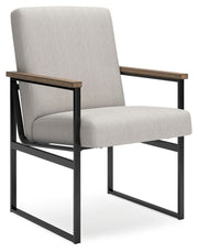 Ashley Furniture Montia home office set featuring a sleek desk and matching chair in a modern design, shown from an angled view.