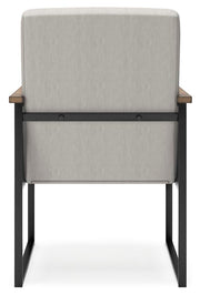Ashley Furniture Montia home office set with a desk and matching chair, shown from the back in a modern workspace.
