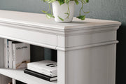 Ashley Furniture Kanwyn Credenza curio with glass doors and wooden shelves, showcasing decorative items and collectibles.