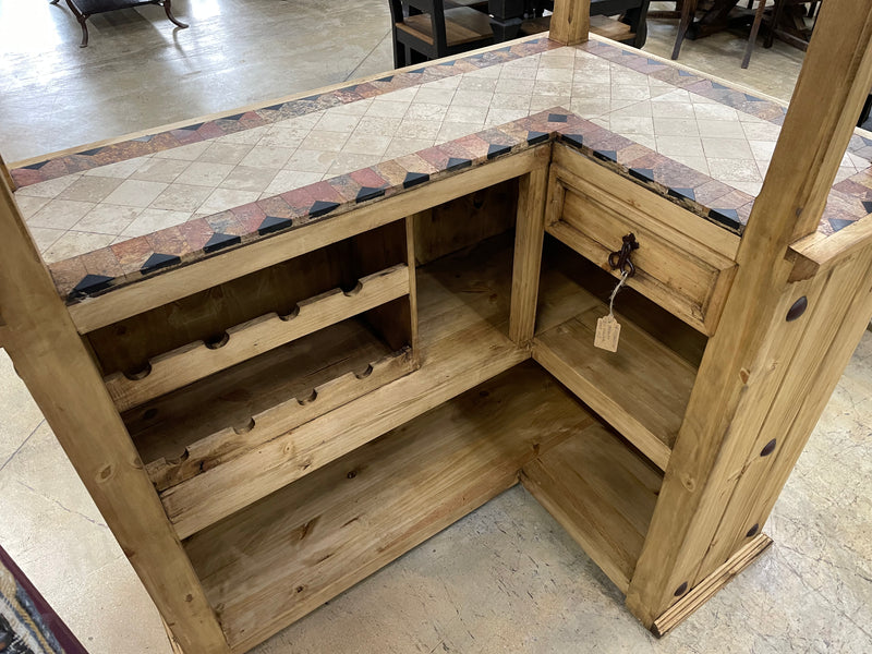 Rustic solid wood Monterrey Furniture cantina bar with travertine top, showcasing its sturdy construction and natural wood finish.