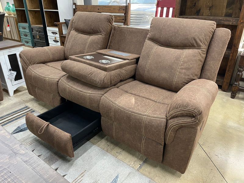 Three-piece manual reclining living room set with plush fabric upholstery by Monterrey Furniture, featuring a sofa and two recliners.
