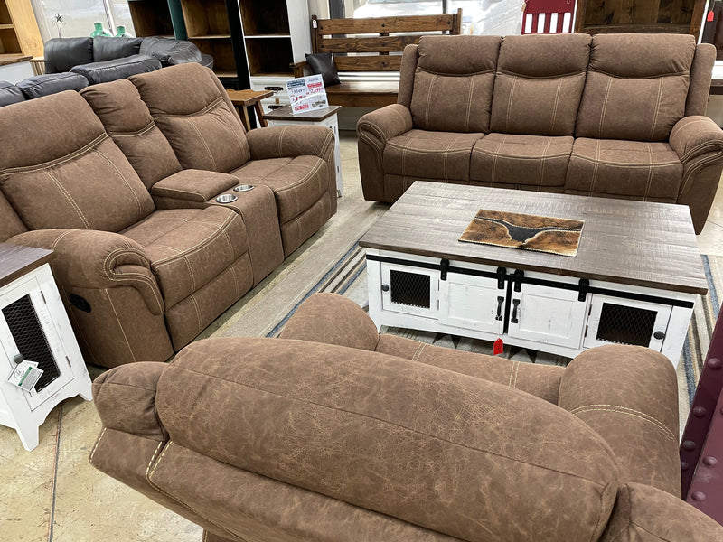 Three-piece manual reclining living room set by Monterrey Furniture featuring plush sofas and matching armchair in a cozy setting.