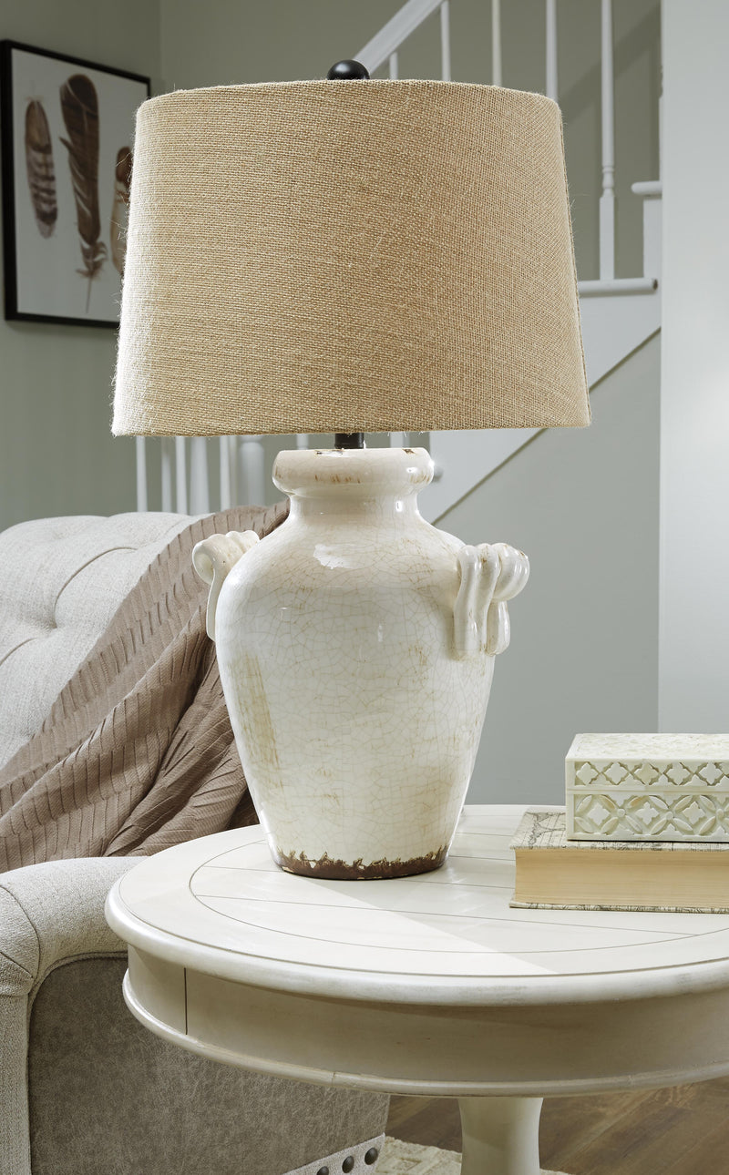 Ashley Furniture Emelda table lamp with a sleek design, featuring a fabric shade and a sturdy base perfect for bedside or living room.