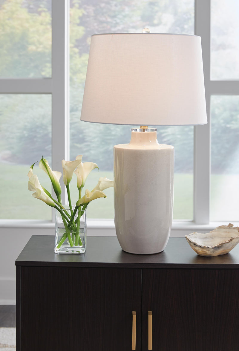 Ashley Furniture Cylener Lamp Set featuring two modern table lamps with fabric shades and sleek bases on a wooden surface.