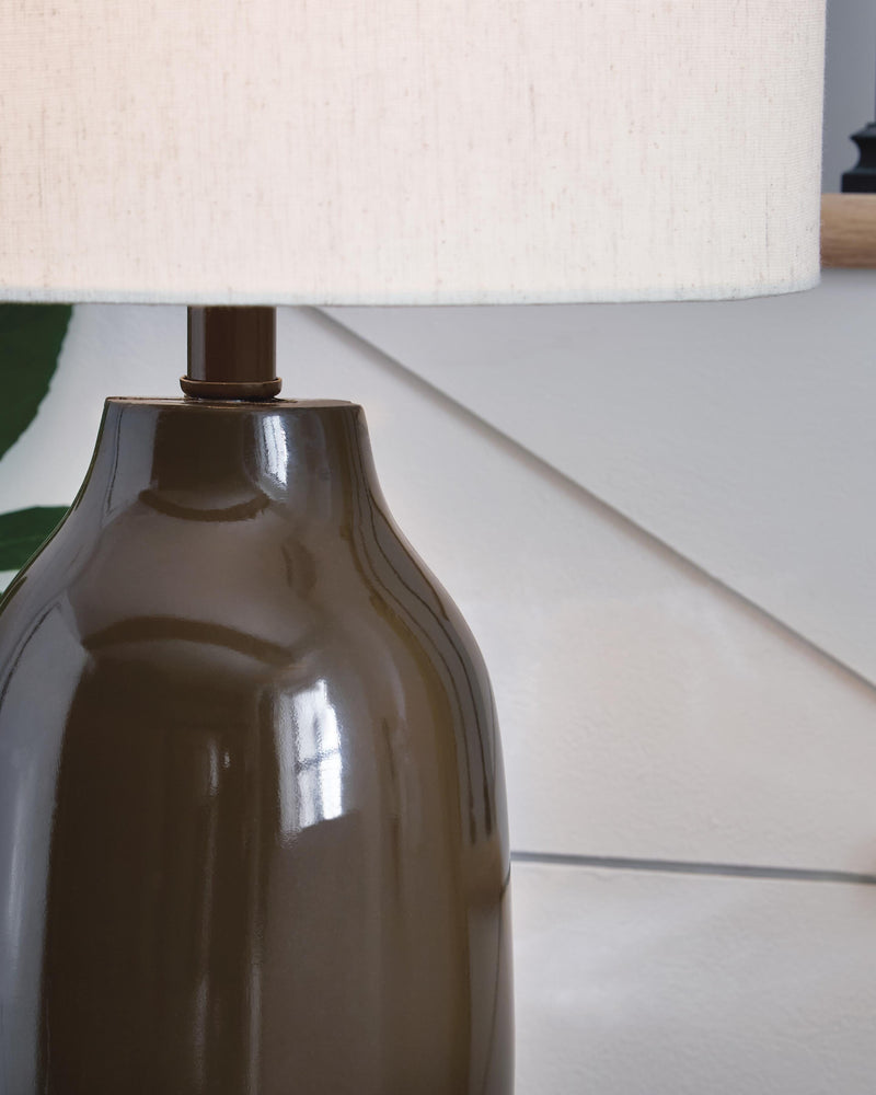 Ashley Furniture Jyler table lamp with a sleek base and fabric shade, ideal for modern living room or bedroom decor.