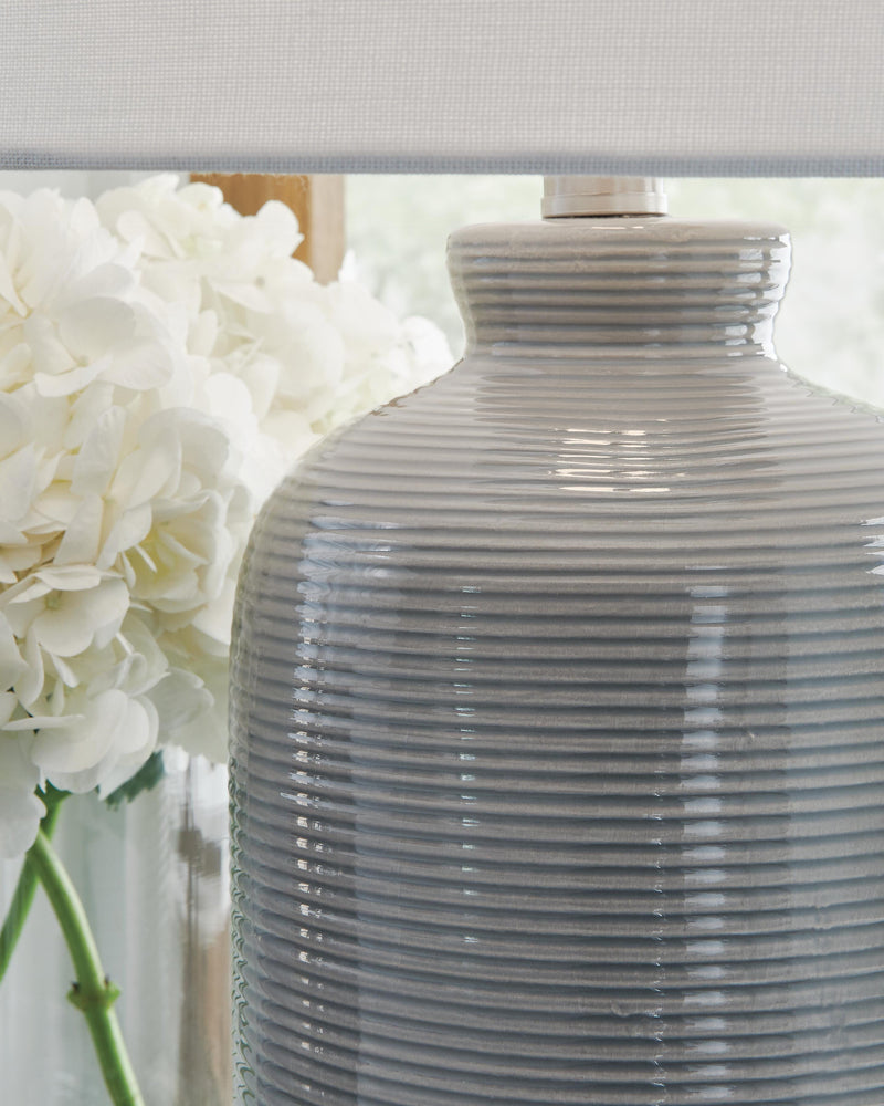 Ashley Furniture Wimlow table lamp with a sleek design and neutral fabric shade, ideal for living room or bedside lighting.