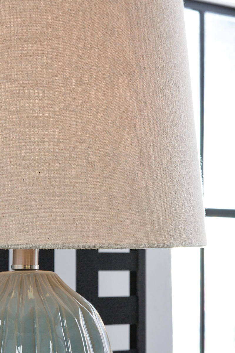 Pair of Hadbury table lamps with beige fabric shades, featuring classic design, by Ashley Furniture, shown with detailed shade close-up.
