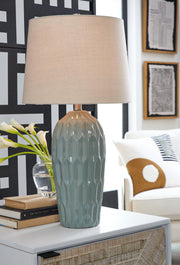 Pair of Hadbury table lamps from Ashley Furniture with beige fabric shades and dark wood bases, ideal for bedside or living room decor.