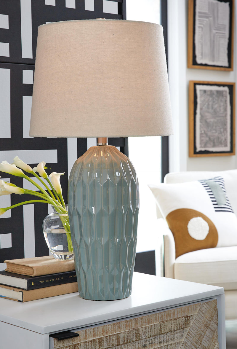 Pair of Hadbury table lamps from Ashley Furniture with beige fabric shades and dark wood bases, ideal for bedside or living room decor.