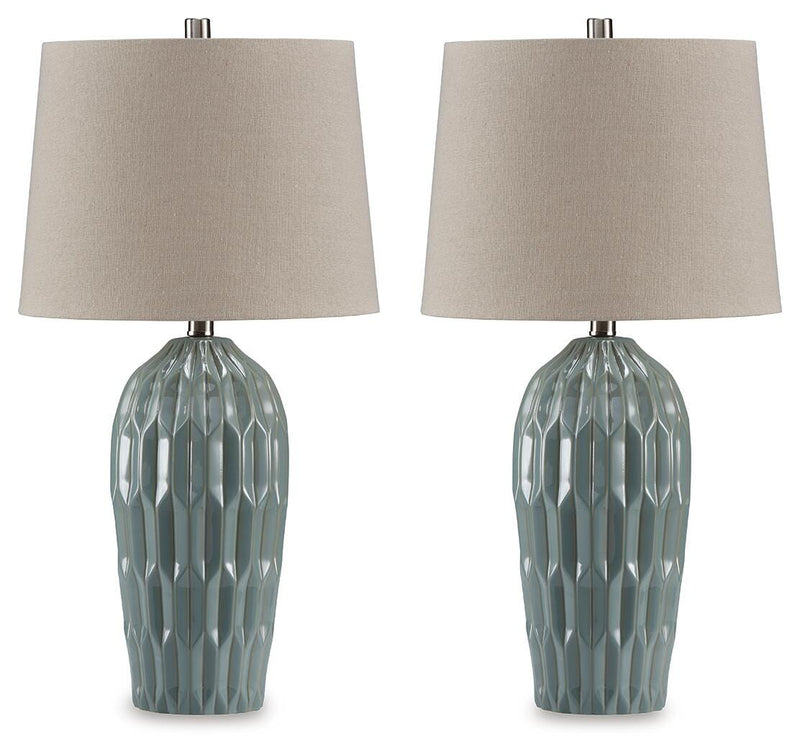 Pair of Hadbury table lamps by Ashley Furniture with cream fabric shades and dark bronze bases on a wooden surface.